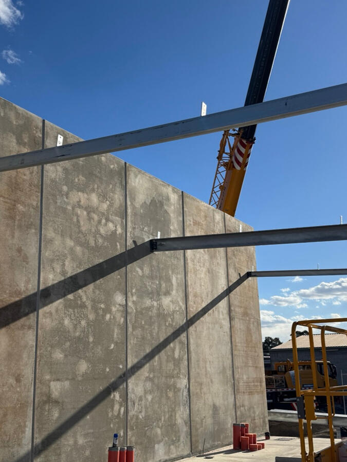Steel framing alongside precast concrete panels